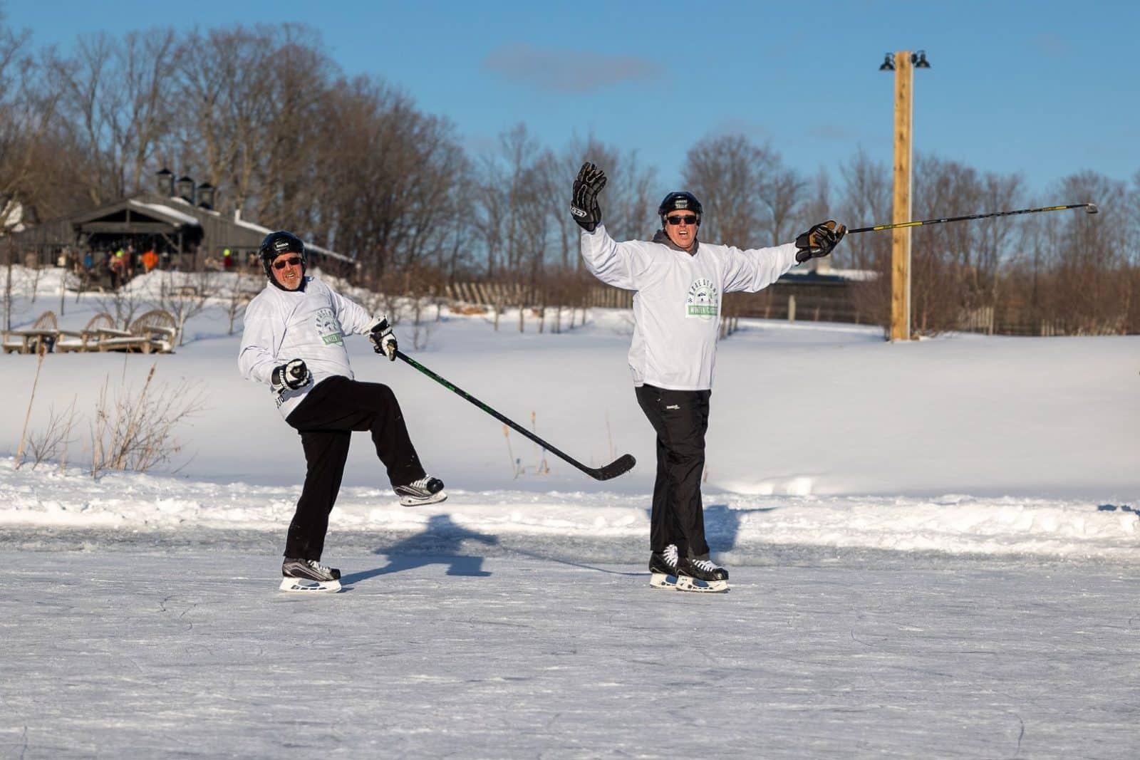 Ted Markle celebrates a goal at the Braestone Winter Classic pond hockey tournament with a fellow team member