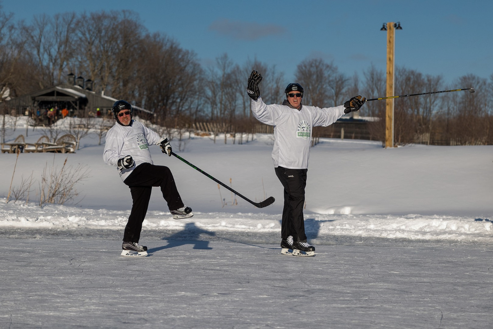 Ted Markle and another player from the 2022 Braestone Winter Classic Pond Hockey Tournament, celebrate a goal.