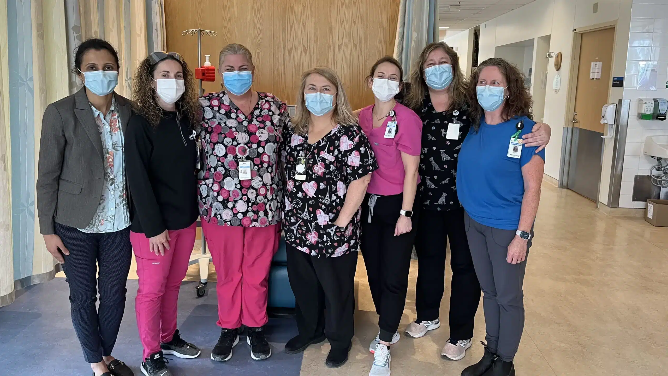 Jolene Bell a nurse at the Simcoe Muskoka Regional Cancer Centre, poses with her colleagues in the cancer centre for a photo

