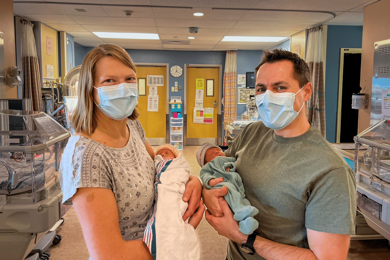 A couple in the Neonatal Intensive Care Unit, with their newborn twins. 
